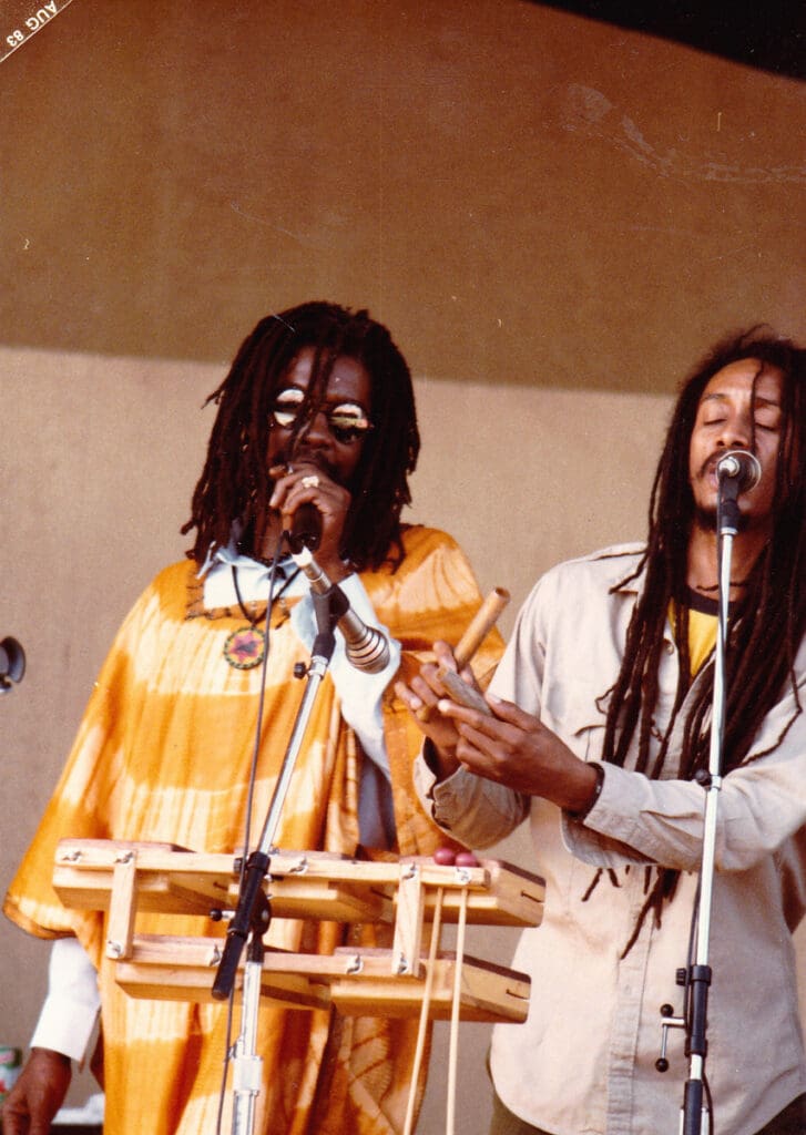 Two men are singing on stage at a concert.